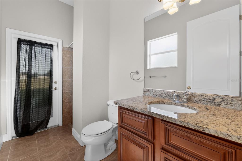 1216 Heavitree Court Sebring, FL 33876 - Photo 21 of 35 a bathroom with a granite countertop toilet sink and shower