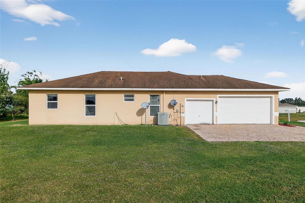 1216 Heavitree Court Sebring, FL 33876 - Photo 29 of 35 a view of front of house with a yard