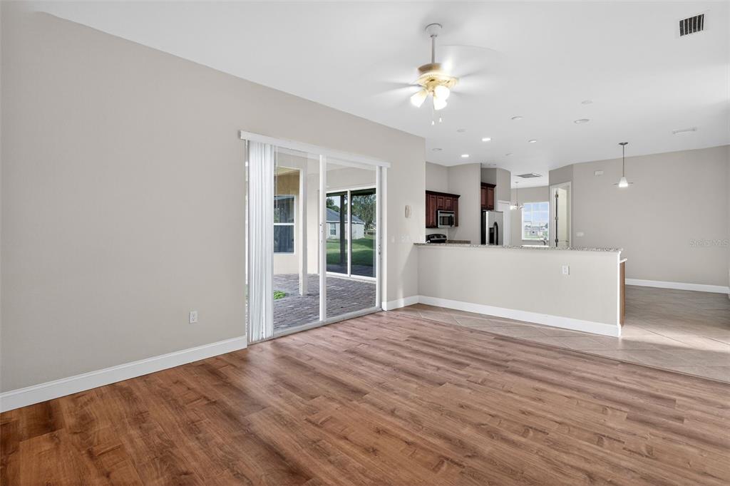 1216 Heavitree Court Sebring, FL 33876 - Photo 6 of 35 a view of a livingroom with a ceiling fan and kitchen view