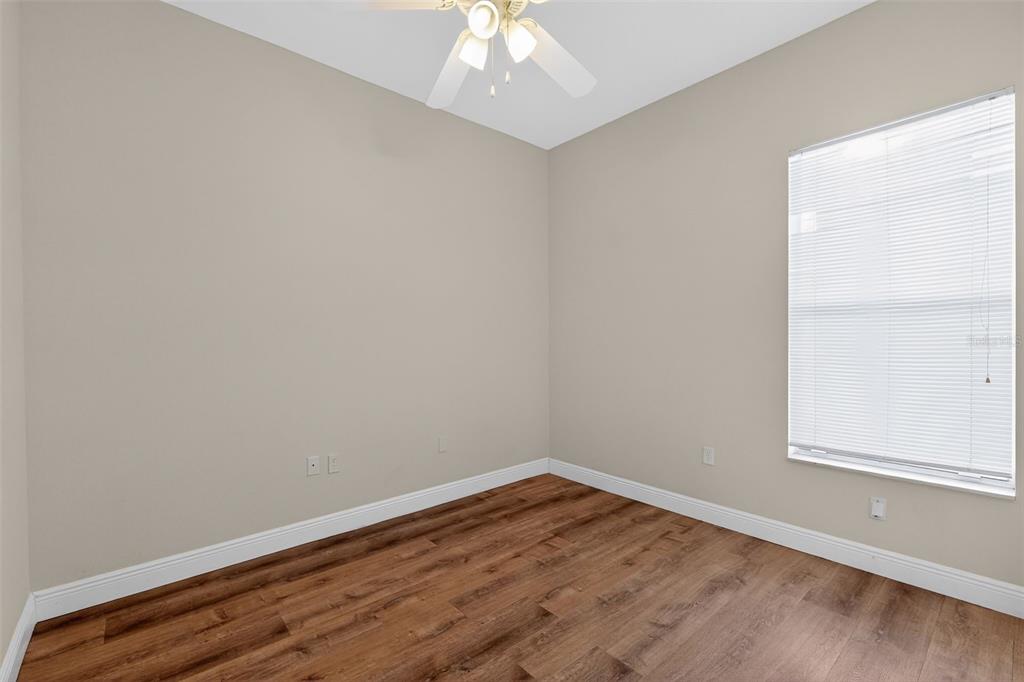 1216 Heavitree Court Sebring, FL 33876 - Photo 8 of 35 an empty room with wooden floor and windows