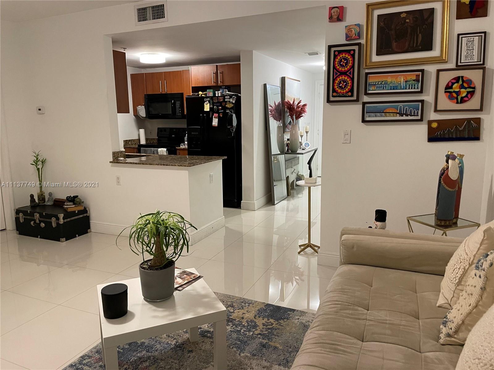 a living room with furniture and a potted plant