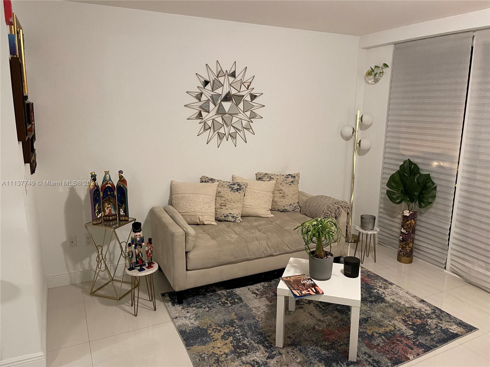 2701 Southwest 3rd Avenue, Unit 202 Miami, FL 33129 - Photo 2 of 26 a living room with furniture and a potted plant
