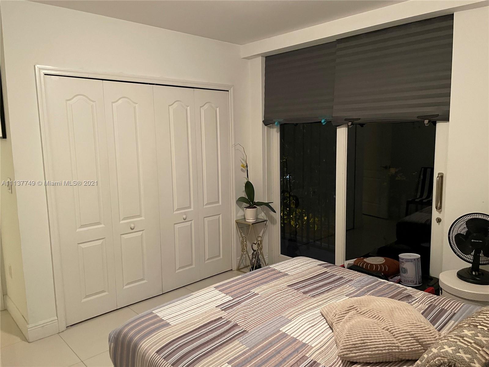 2701 Southwest 3rd Avenue, Unit 202 Miami, FL 33129 - Photo 12 of 26 a bedroom with a bed and a closet