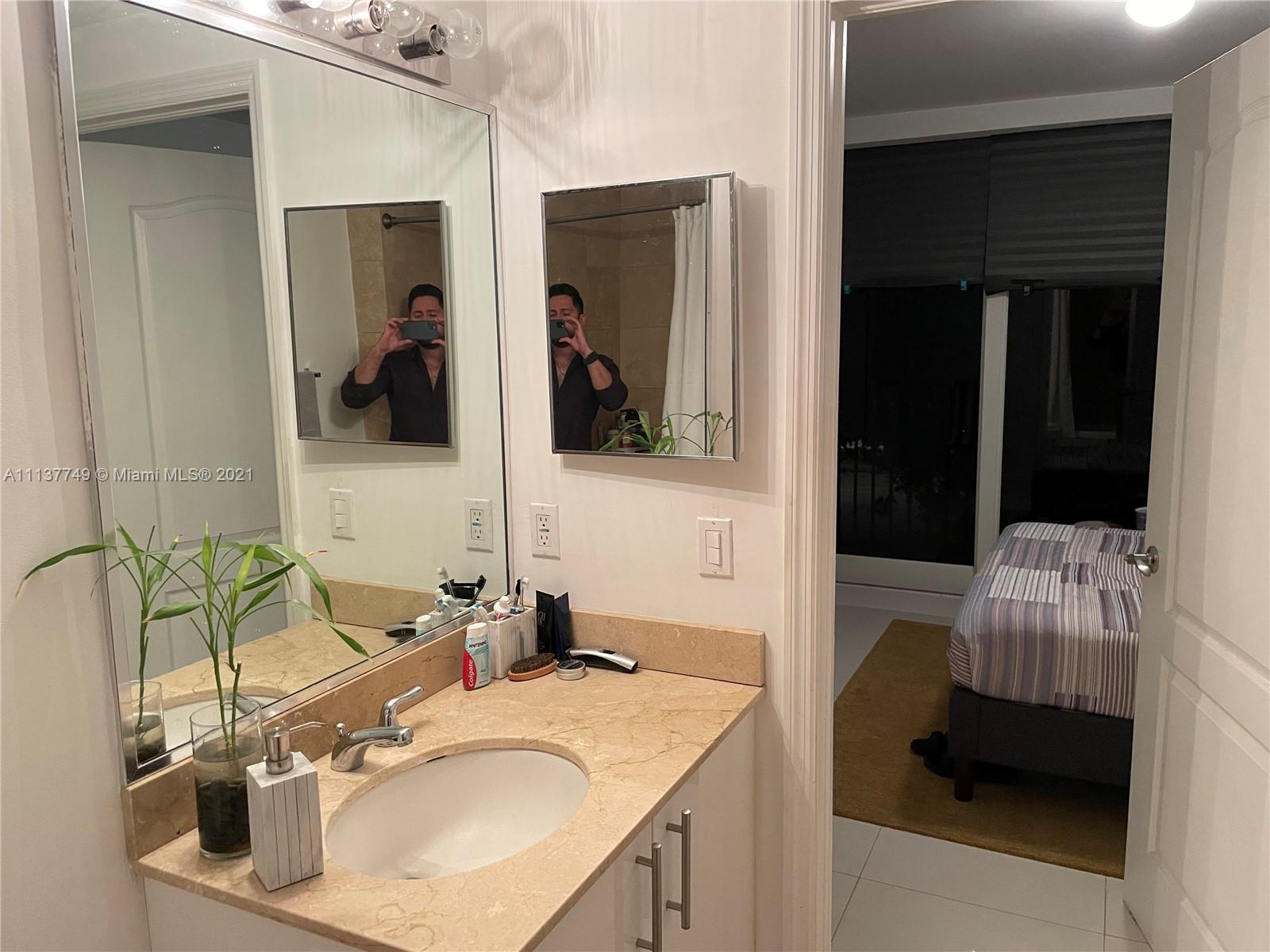 2701 Southwest 3rd Avenue, Unit 202 Miami, FL 33129 - Photo 14 of 26 a en suite bathroom with a sink and mirror