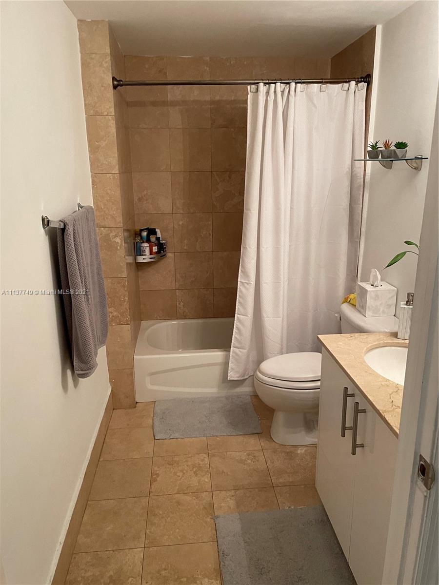 2701 Southwest 3rd Avenue, Unit 202 Miami, FL 33129 - Photo 15 of 26 a bathroom with a sink a toilet and a bathtub
