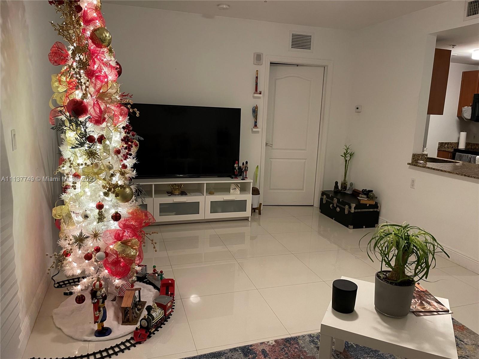 2701 Southwest 3rd Avenue, Unit 202 Miami, FL 33129 - Photo 3 of 26 a living room with furniture and flowers