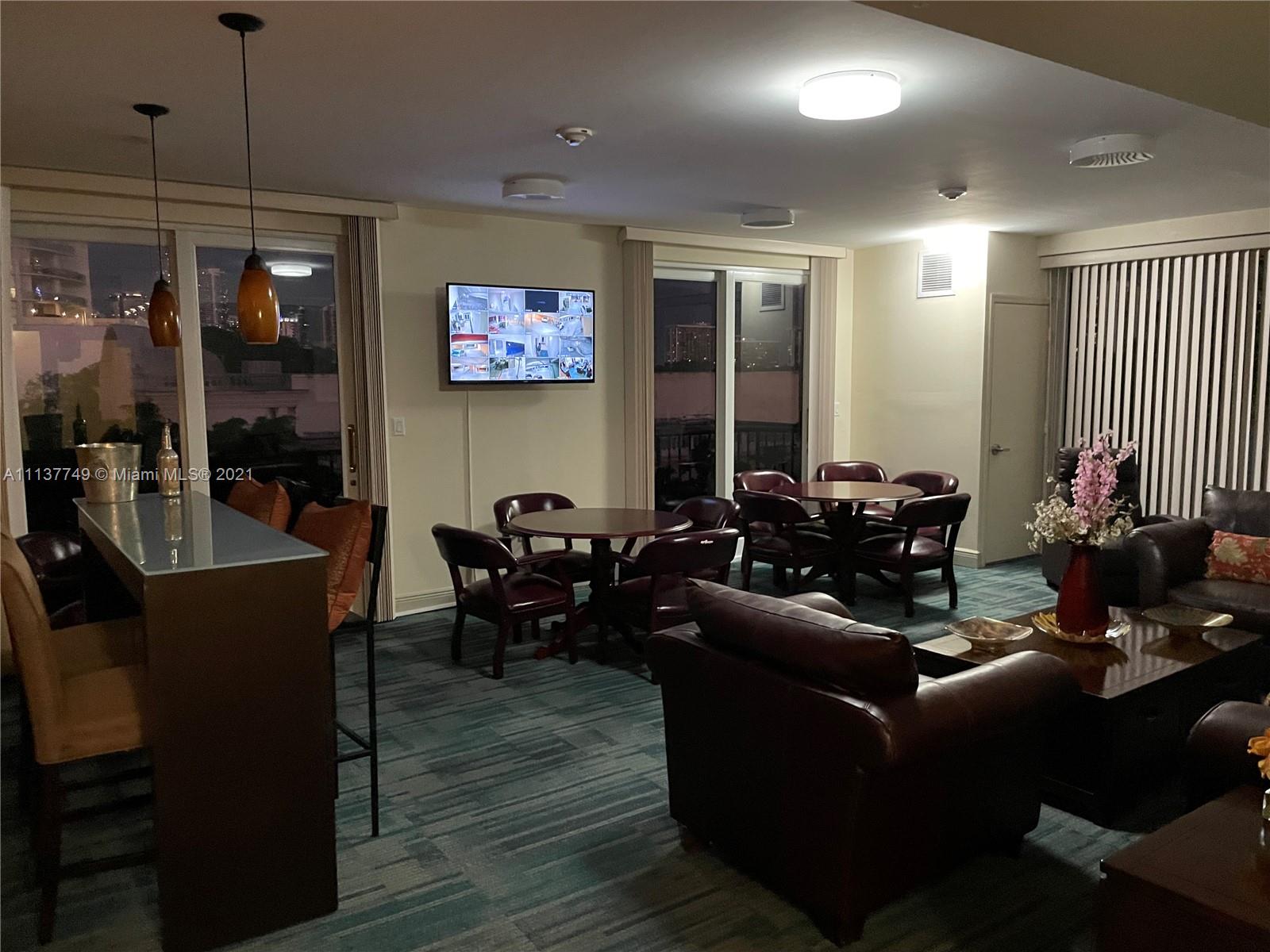 2701 Southwest 3rd Avenue, Unit 202 Miami, FL 33129 - Photo 23 of 26 a living room with furniture and a flat screen tv