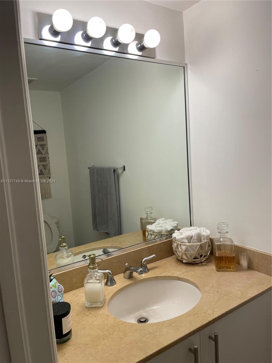2701 Southwest 3rd Avenue, Unit 202 Miami, FL 33129 - Photo 9 of 26 a bathroom with a sink and a mirror