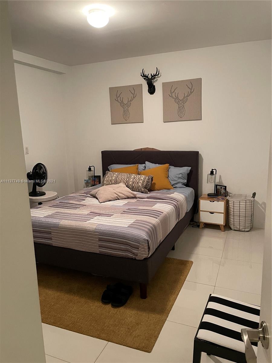 2701 Southwest 3rd Avenue, Unit 202 Miami, FL 33129 - Photo 10 of 26 a bedroom with a bed and wall painting