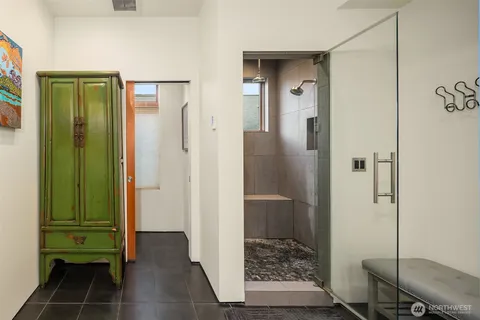 a bathroom with a glass door shower and a sink