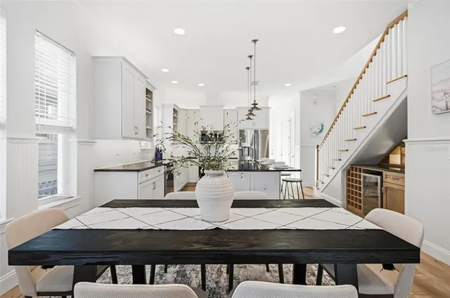 a kitchen with stainless steel appliances granite countertop a sink a stove a refrigerator and island with wooden floor