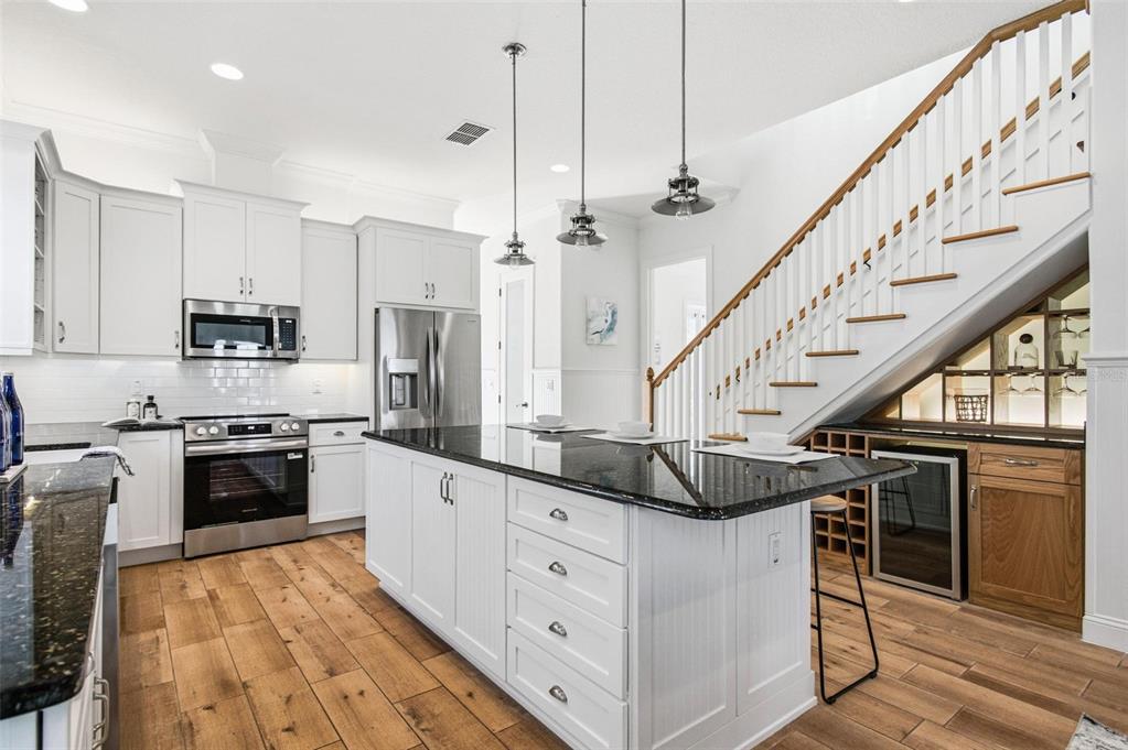 25 Sandy Beach Way Palm Coast, FL 32137 - Photo 14 of 41 a kitchen with stainless steel appliances kitchen island granite countertop a stove a sink and a refrigerator