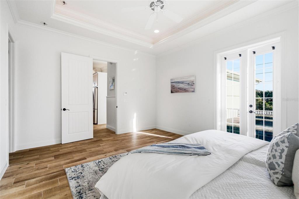 25 Sandy Beach Way Palm Coast, FL 32137 - Photo 17 of 41 a bedroom with a large bed and wooden floor