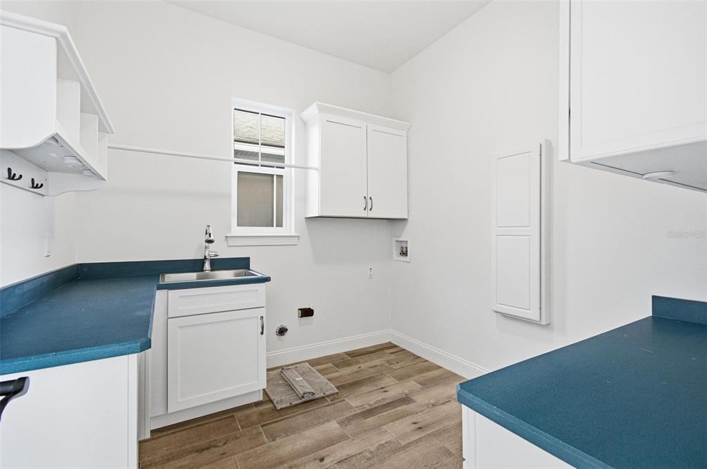 25 Sandy Beach Way Palm Coast, FL 32137 - Photo 37 of 41 a kitchen with granite countertop a sink cabinets and wooden floor