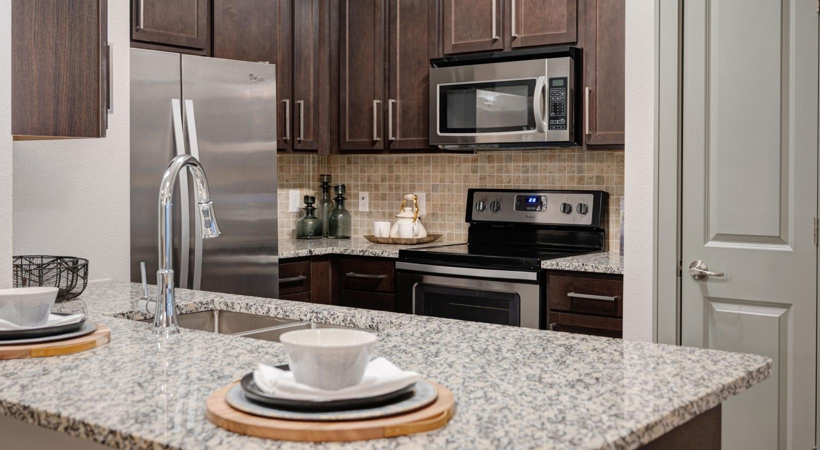2539 Spring Cypress Road, Unit 7317 Spring, TX 77388 - Photo 6 of 13 a kitchen with a stove and a refrigerator
