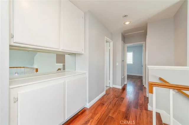 a view of hallway with wooden floor