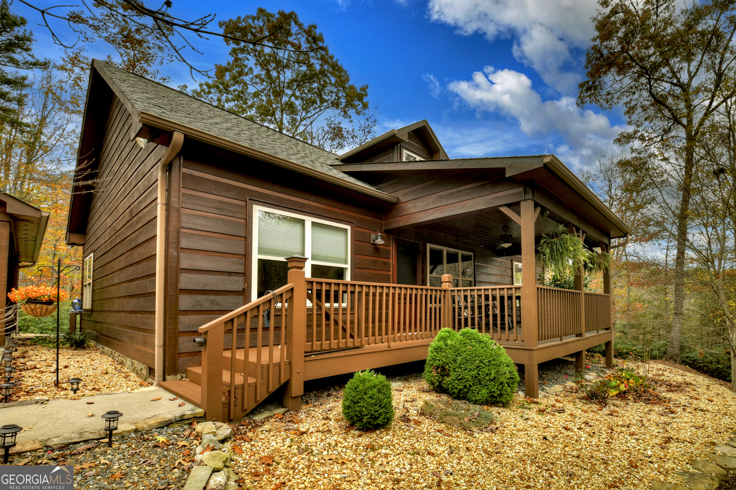 a view of a house with a wooden deck