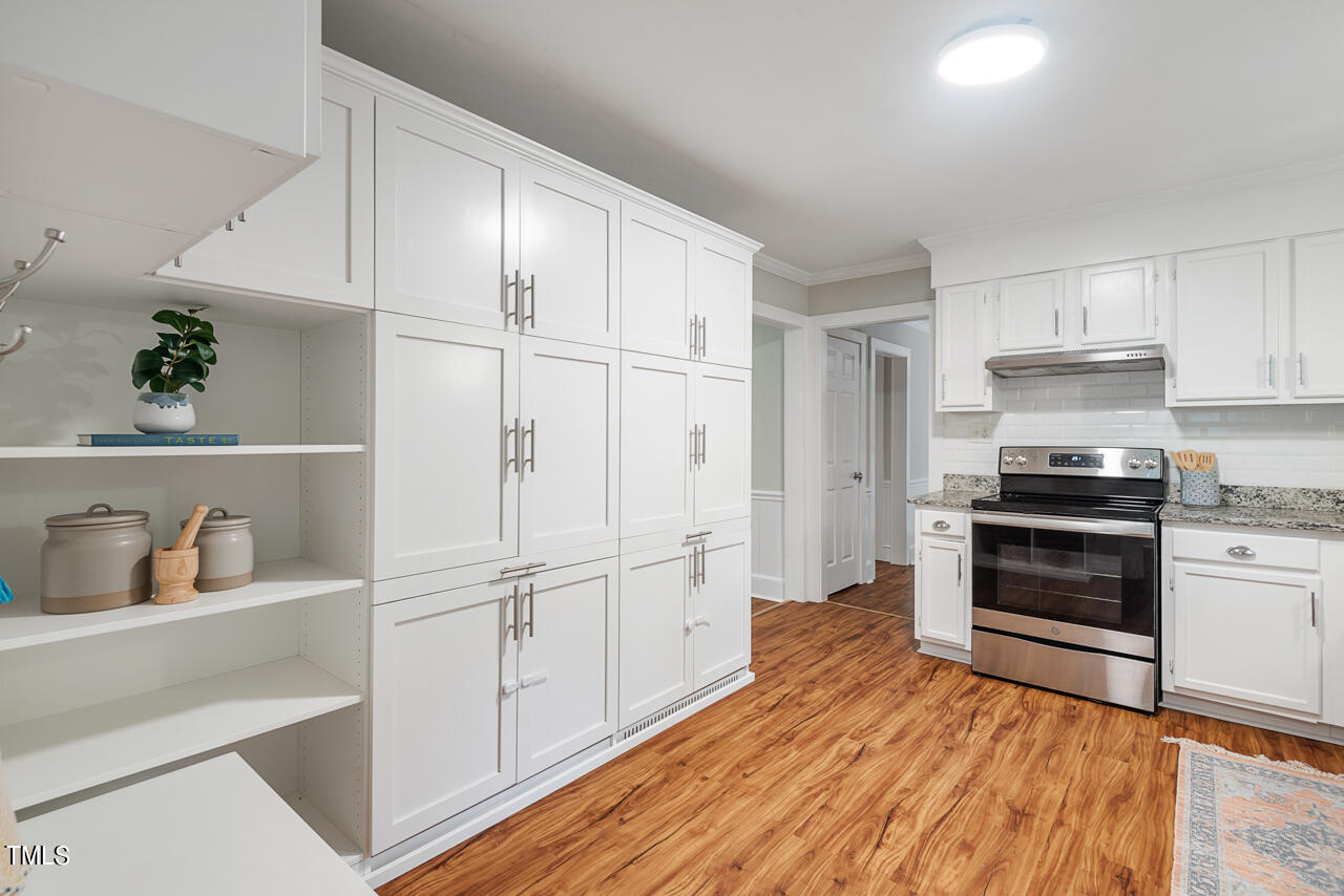 4102 Trotter Ridge Road Durham, NC 27707 - Photo 16 of 41 a kitchen with white cabinets and white appliances