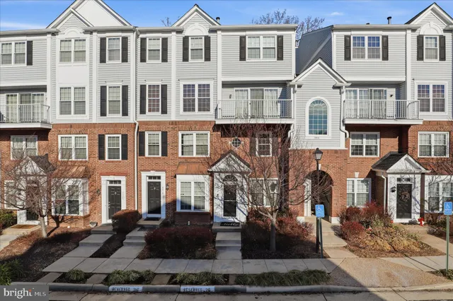 a front view of a residential apartment building with a yard