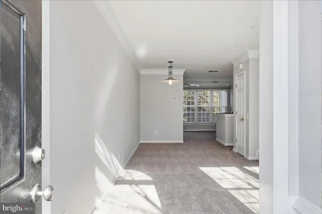 a view of a hallway with wooden shelves
