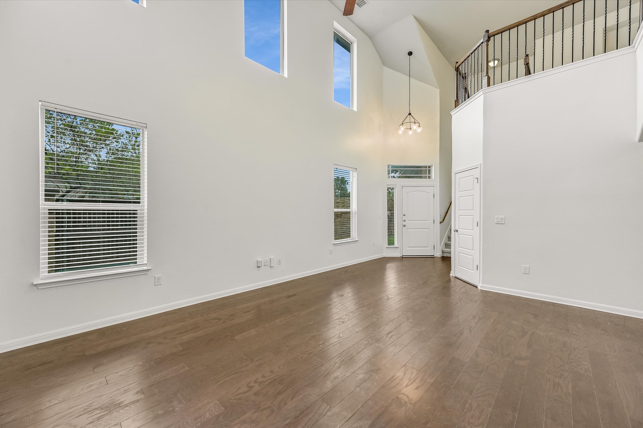 7709 Menchaca Road, Unit 1 Austin, TX 78745 - Photo 8 of 29 Soaring two story living room expands the already spacious room and a wall of windows floods the space with natural light.
