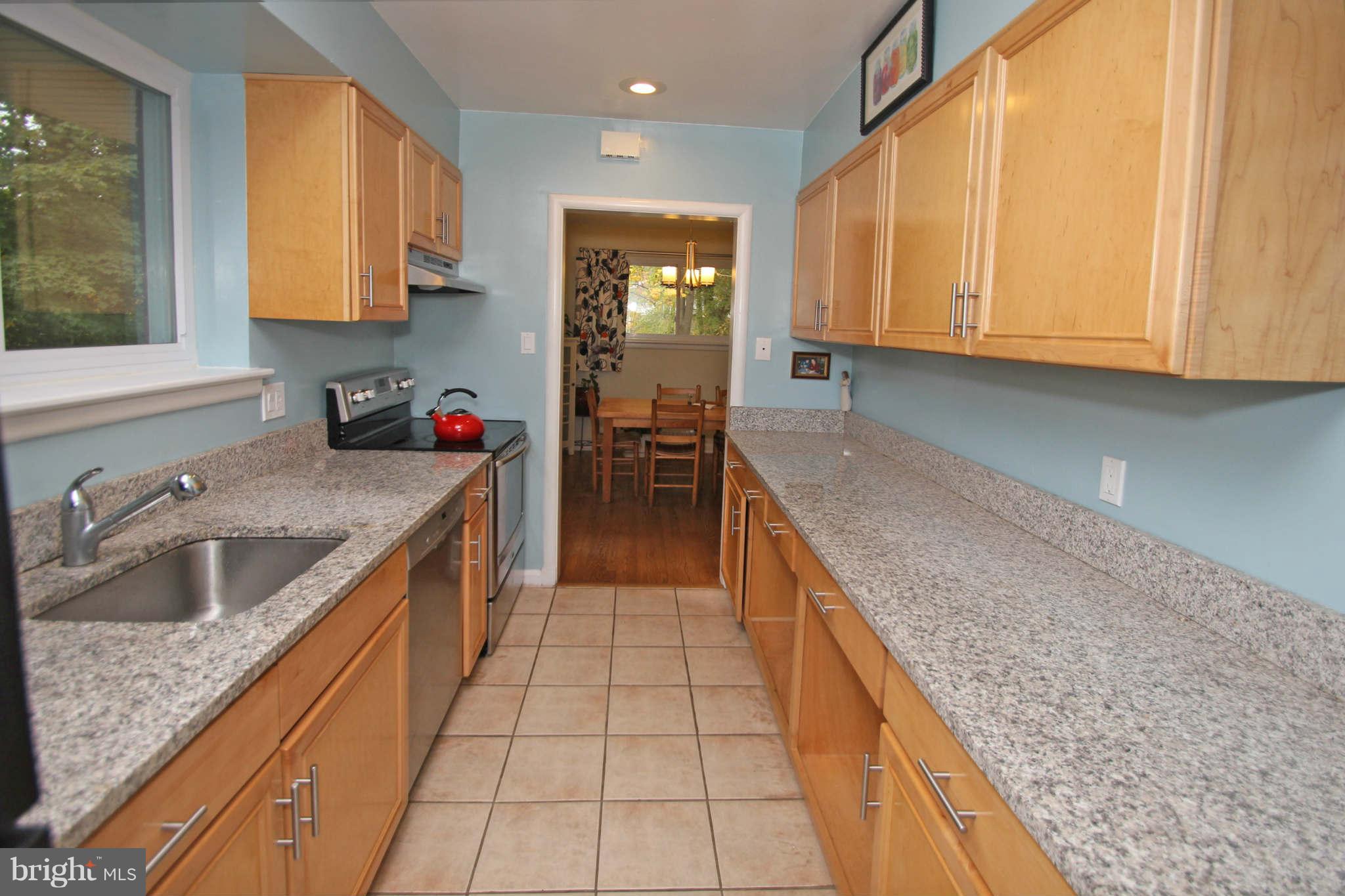 4 Oldham Road Silver Spring, MD 20901 - Photo 11 of 27 a kitchen with a sink stove and cabinets