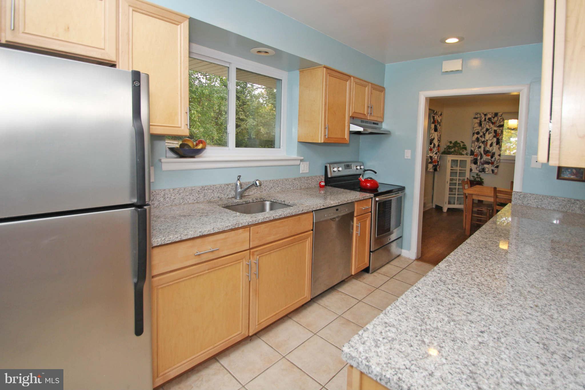 4 Oldham Road Silver Spring, MD 20901 - Photo 12 of 27 a kitchen with stainless steel appliances granite countertop a refrigerator sink and white cabinets
