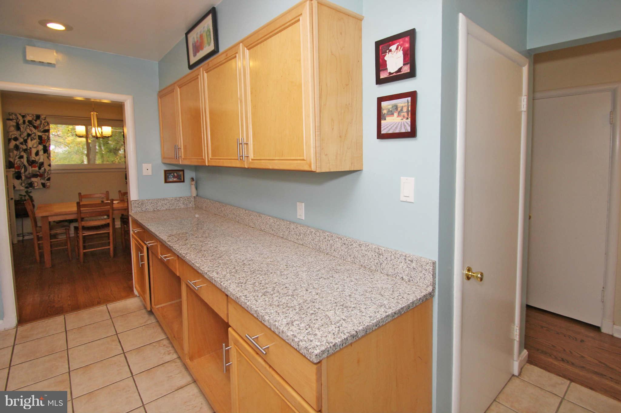4 Oldham Road Silver Spring, MD 20901 - Photo 13 of 27 a kitchen with granite countertop a coffee maker on granite counter tops and white cabinets