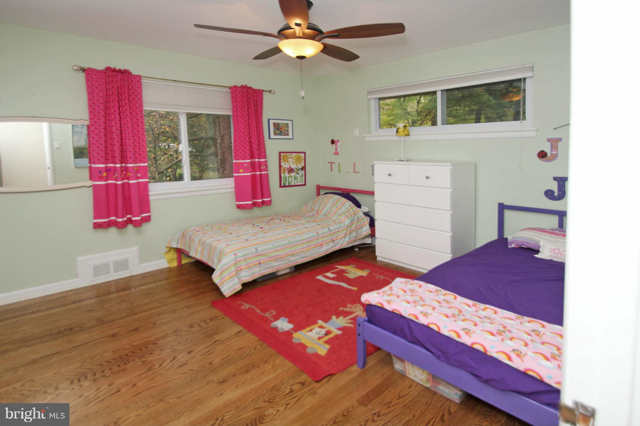 4 Oldham Road Silver Spring, MD 20901 - Photo 18 of 27 a bedroom with a bed and a dresser with wooden floor