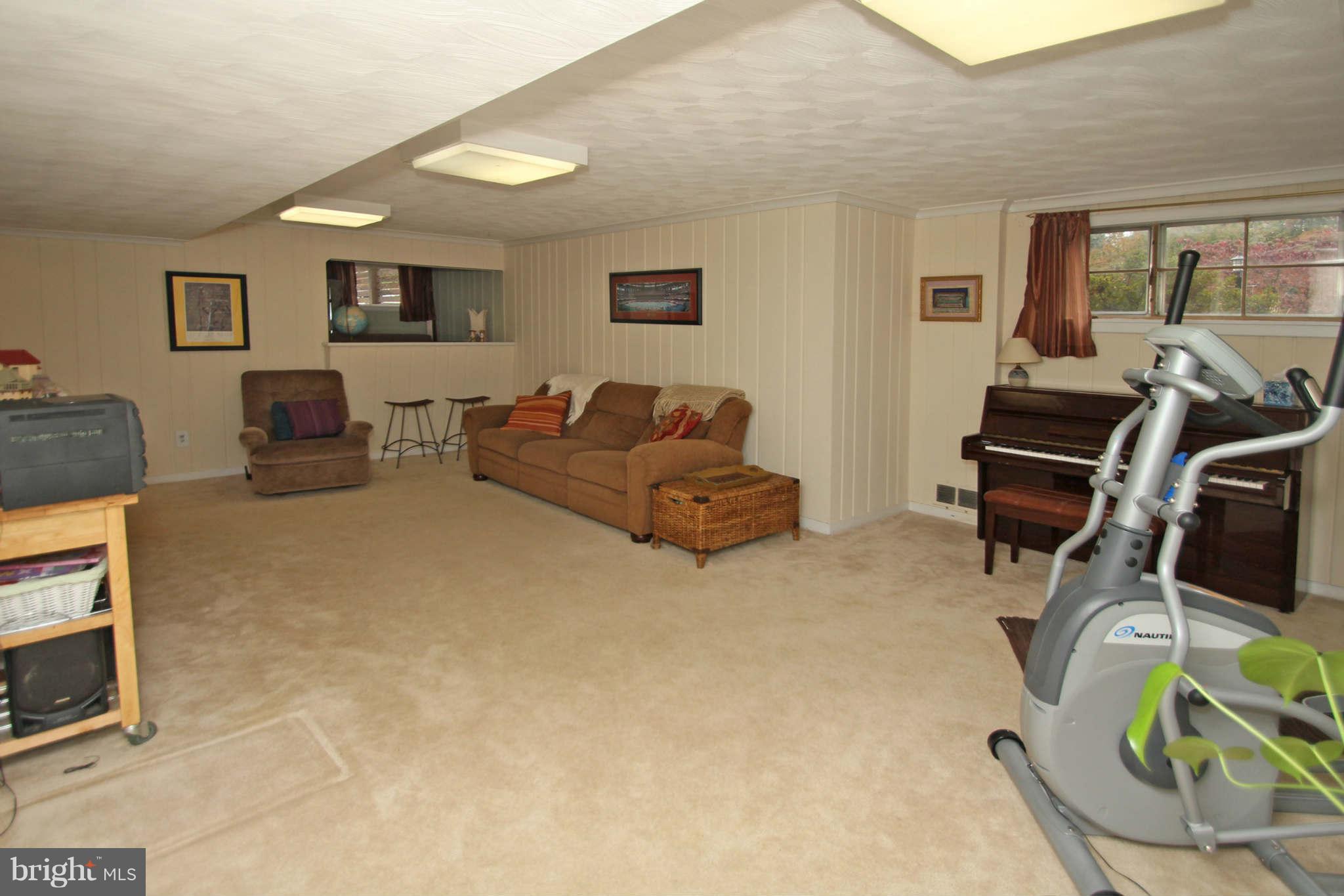 4 Oldham Road Silver Spring, MD 20901 - Photo 21 of 27 a living room with furniture a window and gym equipment