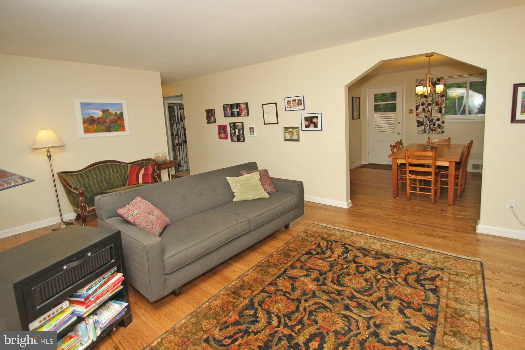 4 Oldham Road Silver Spring, MD 20901 - Photo 4 of 27 a living room with furniture and a dining table with wooden floor