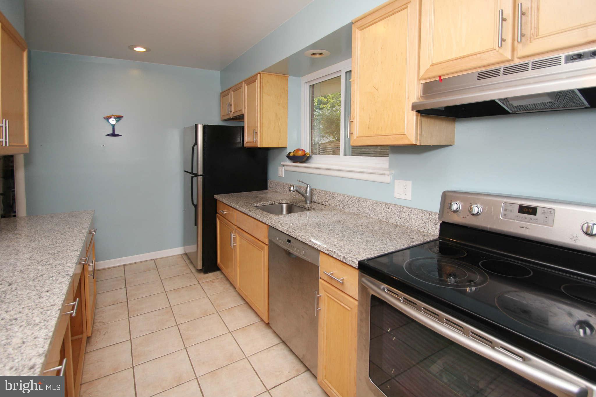 4 Oldham Road Silver Spring, MD 20901 - Photo 10 of 27 a kitchen with stainless steel appliances granite countertop a sink stove and refrigerator
