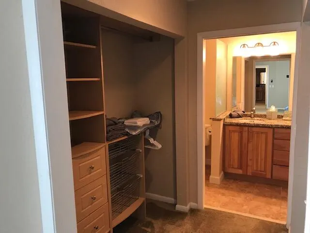 a patio with a table and chairs under an umbrella