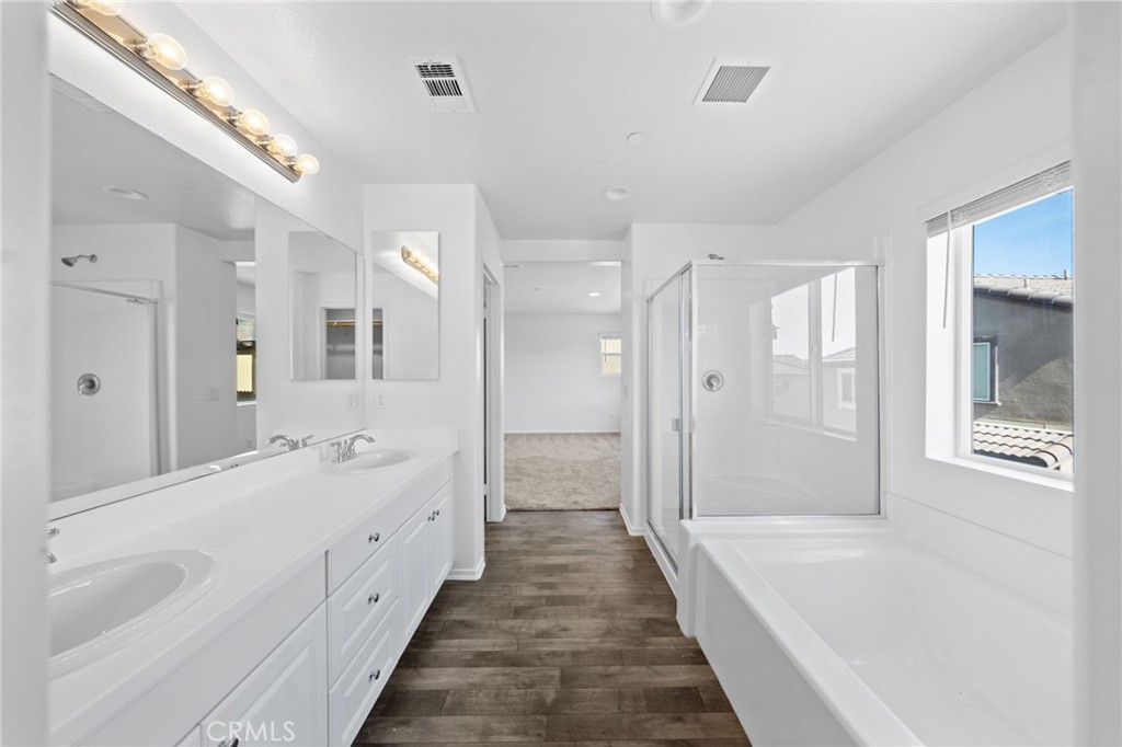 259 Spotted Saddle Way Fallbrook, CA 92028 - Photo 18 of 43 a bathroom with a bathtub shower and a sink