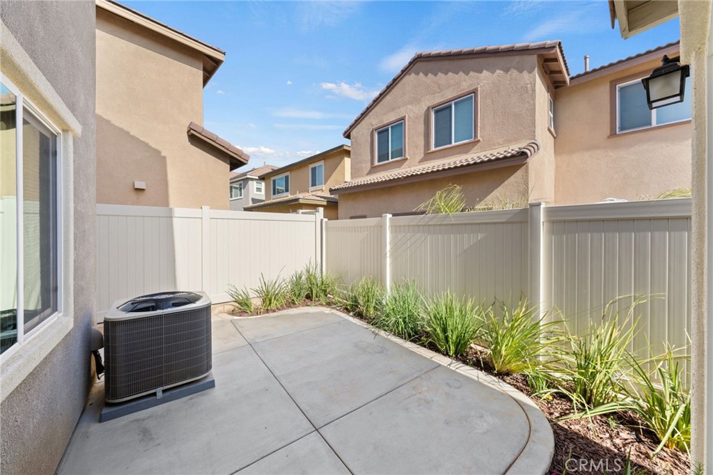 259 Spotted Saddle Way Fallbrook, CA 92028 - Photo 33 of 43 a backyard of a house with potted plants and brick wall
