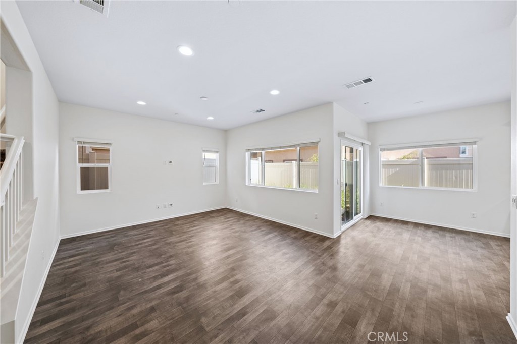 259 Spotted Saddle Way Fallbrook, CA 92028 - Photo 6 of 43 a view of an empty room with wooden floor and a window