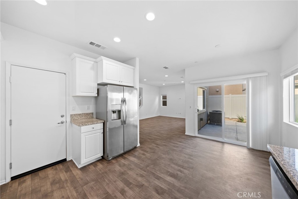 259 Spotted Saddle Way Fallbrook, CA 92028 - Photo 9 of 43 a kitchen with refrigerator and cabinets