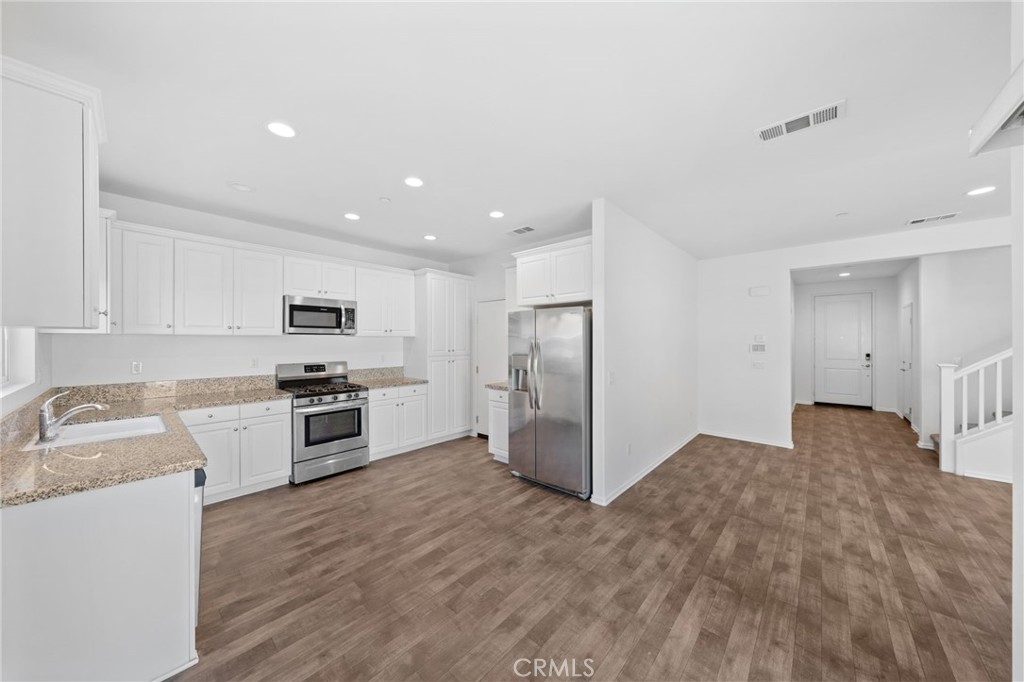 259 Spotted Saddle Way Fallbrook, CA 92028 - Photo 10 of 43 a kitchen with stainless steel appliances a refrigerator and a stove top oven