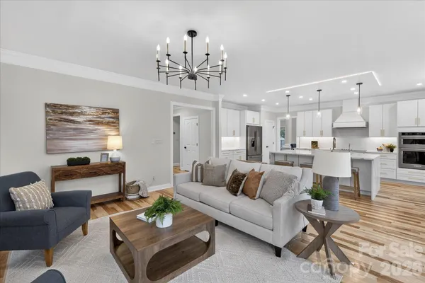a living room with furniture and kitchen view