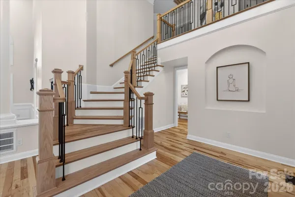 a view of entryway and hall with wooden floor