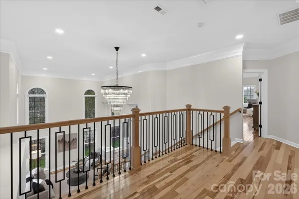 a view of hallway with wooden floor and stairs