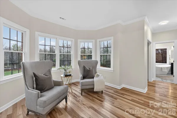 a living room with furniture a window and wooden floor