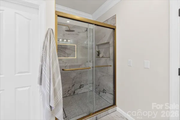 a bathroom with a glass shower door
