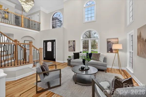 a living room with furniture fireplace and a large window