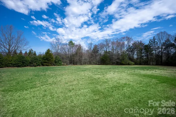 a view of outdoor space with green field and trees
