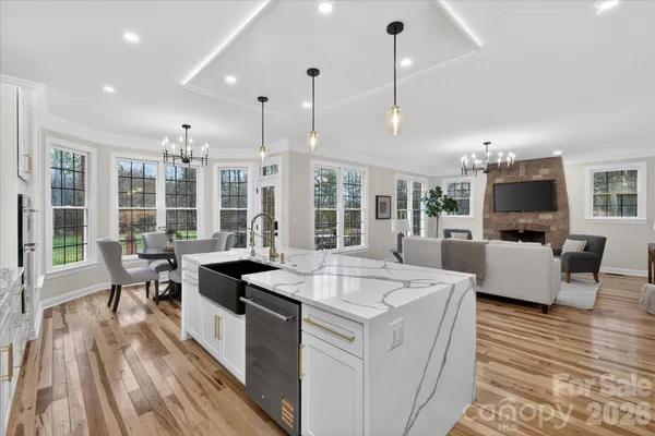 a open kitchen with sink table and chairs
