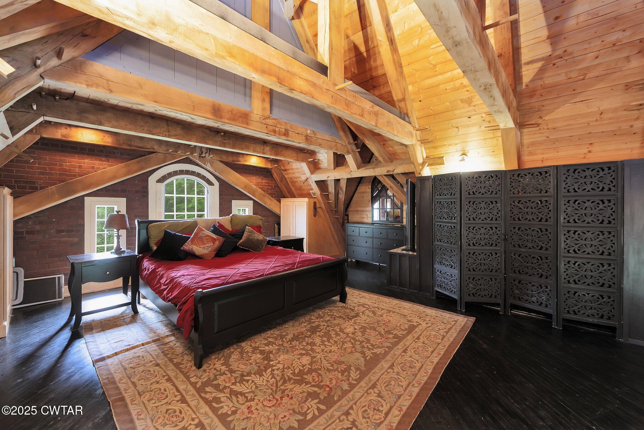 1620 Dry Creek Road Pinson, TN 38366 - Photo 20 of 51 a bedroom with a bed a dresser and wooden floor