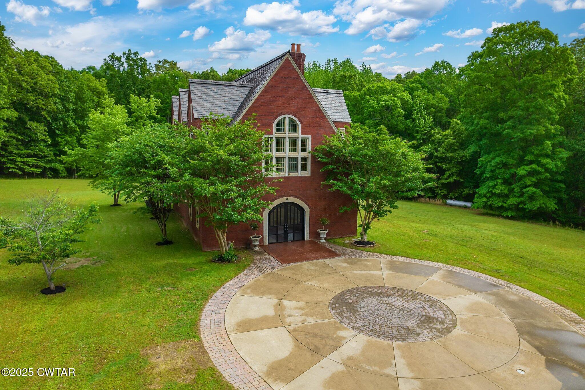 1620 Dry Creek Road Pinson, TN 38366 - Photo 44 of 51 a front view of a house with a garden