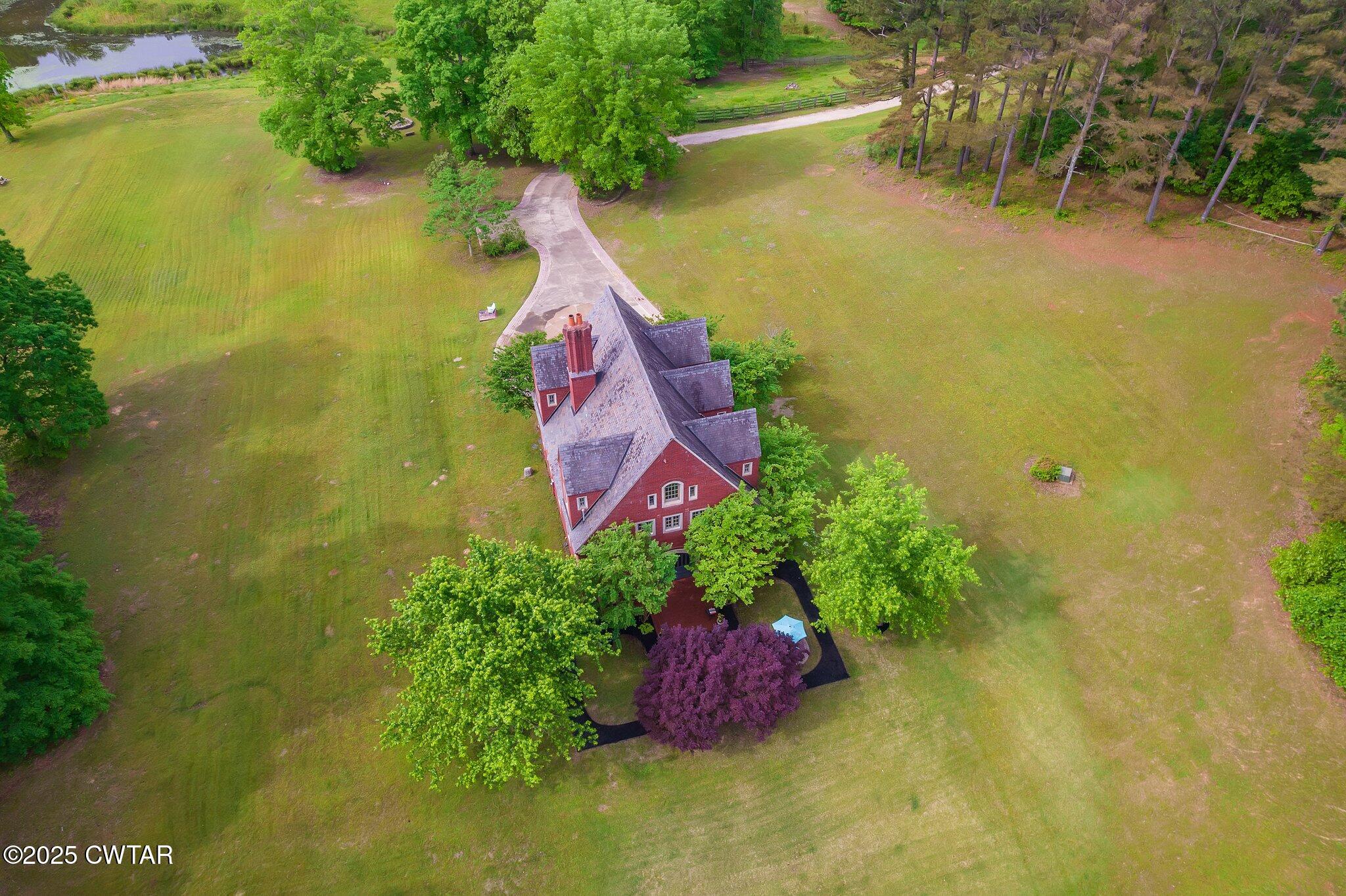 1620 Dry Creek Road Pinson, TN 38366 - Photo 48 of 51 a view of a lake with a house in the background