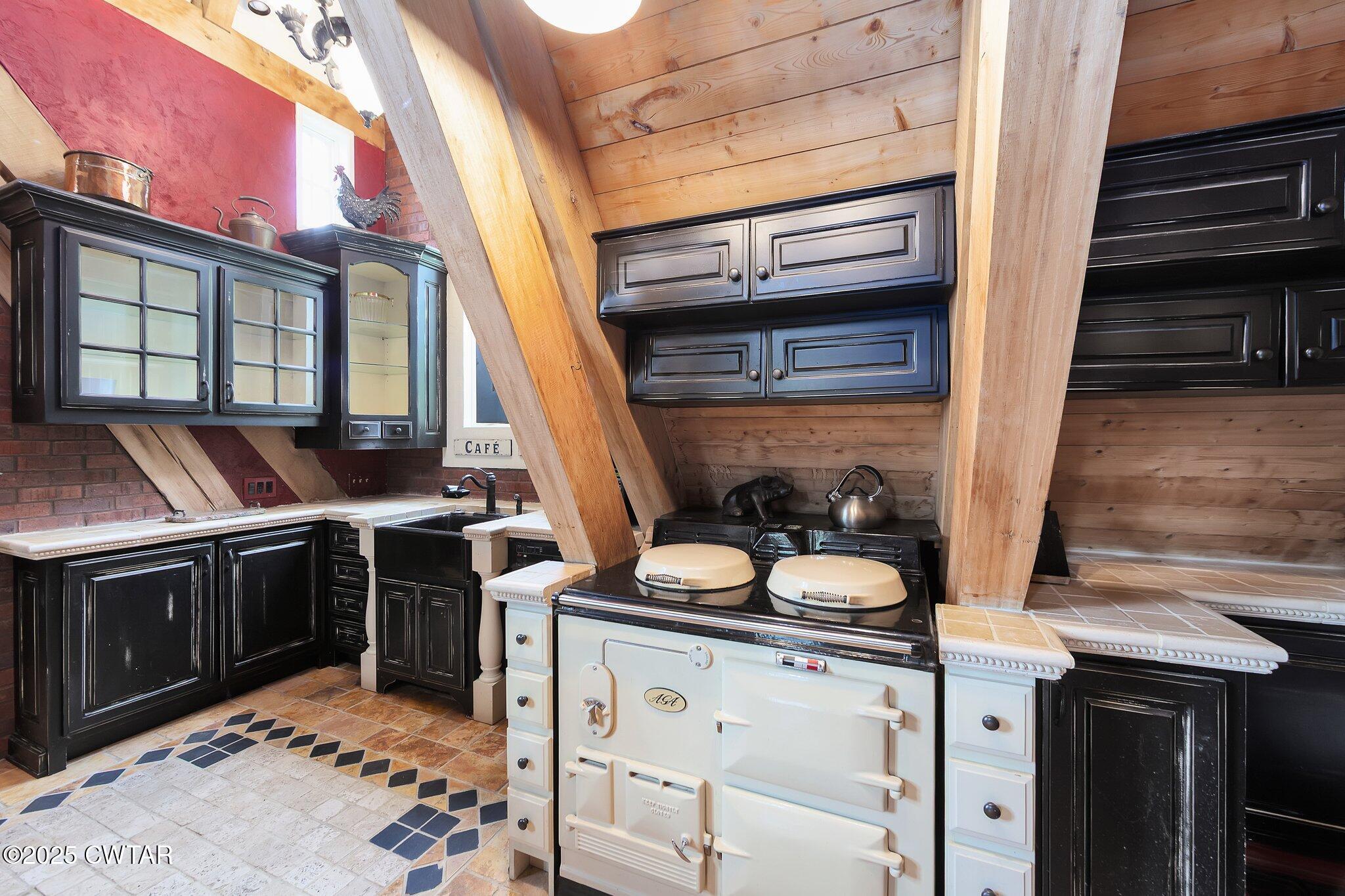1620 Dry Creek Road Pinson, TN 38366 - Photo 6 of 51 a kitchen with stainless steel appliances granite countertop a stove and a sink